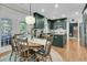 Inviting dining area with wooden table, a stylish light fixture, and easy access to the outdoors at 1828 S James Gregarie Rd, Mount Pleasant, SC 29466