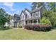 Inviting two-story home featuring a manicured lawn and charming front porch at 1828 S James Gregarie Rd, Mount Pleasant, SC 29466