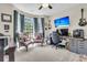 Bright home office with a large bay window, custom desk, and comfortable seating at 1828 S James Gregarie Rd, Mount Pleasant, SC 29466