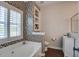 Inviting bathroom featuring mosaic tile, a built-in shelf, and abundant natural light at 1852 Pierce St, Charleston, SC 29492