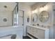 Bright bathroom featuring double sinks, vanity, modern fixtures, and glass shower at 1852 Pierce St, Charleston, SC 29492