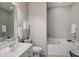 Bright bathroom with a soaking tub, white tile, neutral paint, and a framed mirror at 1852 Pierce St, Charleston, SC 29492