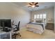 Neutral bedroom setup with desk, carpet, ceiling fan, shuttered window, and modern bed at 1852 Pierce St, Charleston, SC 29492
