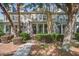 Charming townhome featuring a landscaped front yard, inviting entrance, and American flag at 1852 Pierce St, Charleston, SC 29492