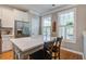 Bright kitchen featuring a large island, stainless appliances, and natural light from shuttered windows at 1852 Pierce St, Charleston, SC 29492