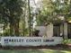 An exterior shot of Berkeley County Library with a sign and lush greenery at 1852 Pierce St, Charleston, SC 29492