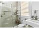 Bright bathroom with a glass shower, a modern sink, and white tiling at 19 Smith St # A, Charleston, SC 29401