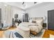 Airy bedroom showcasing a king-sized bed, stylish decor, and ample natural light at 19 Smith St # A, Charleston, SC 29401