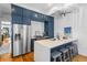 Bright kitchen boasts navy cabinets, stainless steel appliances, and a large island with seating at 19 Smith St # A, Charleston, SC 29401