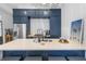 Kitchen island with white countertops, seating, stainless appliances, and stylish decor at 19 Smith St # A, Charleston, SC 29401