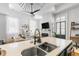 Open kitchen with stainless steel sink and view to the fireplace and living room at 19 Smith St # A, Charleston, SC 29401