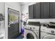 Well-organized laundry room with modern appliances and storage cabinets at 19 Smith St # A, Charleston, SC 29401