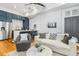 Open-concept living room connected to a modern kitchen featuring a large sofa at 19 Smith St # A, Charleston, SC 29401
