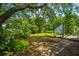 Relaxing backyard features a hammock, tree swing, and lush foliage, perfect for outdoor living at 1918 Piper Dr, Charleston, SC 29407