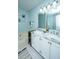 Bathroom featuring a soaking tub, marble vanity, and modern lighting fixtures at 1918 Piper Dr, Charleston, SC 29407