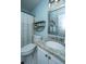 Well-lit bathroom featuring a granite countertop, framed mirror, stylish shelves, and a shower curtain at 1918 Piper Dr, Charleston, SC 29407