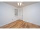 Bright bedroom featuring hardwood floors, a ceiling fan, a window and a white door at 1918 Piper Dr, Charleston, SC 29407
