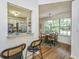 View from breakfast bar into the dining room, featuring hardwood floors and a sunlit window at 1918 Piper Dr, Charleston, SC 29407