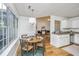Dining area with hardwood floors next to kitchen, featuring a table with seating for four and lots of light at 1918 Piper Dr, Charleston, SC 29407