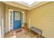 Covered front porch with a blue door, wooden deck, and white trim detailing at 1918 Piper Dr, Charleston, SC 29407