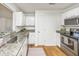 Kitchen with white cabinets, granite countertops, stainless steel appliances, and hardwood floors at 1918 Piper Dr, Charleston, SC 29407