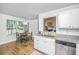 Bright kitchen featuring white cabinets, granite countertops, and a stainless steel dishwasher at 1918 Piper Dr, Charleston, SC 29407