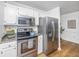 Modern kitchen features stainless steel appliances and granite countertops with ample cabinet space at 1918 Piper Dr, Charleston, SC 29407