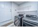Convenient laundry area featuring modern washer and dryer with shelving for extra storage at 1918 Piper Dr, Charleston, SC 29407