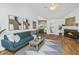 Bright living room boasts a fireplace, vaulted ceiling with fan, hardwood floors and an open floor plan at 1918 Piper Dr, Charleston, SC 29407