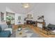 Open-concept living room with a fireplace, hardwood floors, and comfortable seating, leading to a dining area at 1918 Piper Dr, Charleston, SC 29407