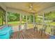 Relaxing screened porch with wooden floors, ceiling fan, outdoor furniture, and peaceful backyard views at 1918 Piper Dr, Charleston, SC 29407