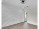 Light-filled bedroom boasts an elegant accent wall, modern fan, and sleek wood-look floors at 1991 Joppa Ave, North Charleston, SC 29405