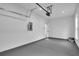 Large garage features a modern door, updated operating system and clean, painted walls at 1991 Joppa Ave, North Charleston, SC 29405