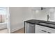 Modern kitchen features black countertops, stainless steel dishwasher, and white cabinets at 1991 Joppa Ave, North Charleston, SC 29405