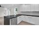 Open-concept kitchen with stainless steel appliances, white cabinets, black marble countertops, and subway tile backsplash at 1991 Joppa Ave, North Charleston, SC 29405