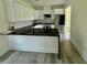 Open kitchen features white cabinets, sleek countertops, stainless appliances, and breakfast bar at 1991 Joppa Ave, North Charleston, SC 29405