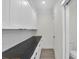 Pantry featuring white cabinetry, black marble countertop, subway tile backsplash, and light wood floors at 1991 Joppa Ave, North Charleston, SC 29405