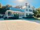 Charming white two-story home with a metal roof, brick chimney and a spacious front porch at 203 Oak View Way, Summerville, SC 29483