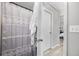 A bathroom featuring gray shower curtain and view into adjacent bedroom at 207 Allen Richard Ct # B, Moncks Corner, SC 29461