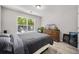 Well-lit bedroom with modern gray vinyl floors, large window and dresser with mounted television at 207 Allen Richard Ct # B, Moncks Corner, SC 29461