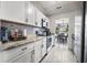 A kitchen featuring white cabinets, granite countertops, stainless appliances and a gray tile backsplash at 207 Allen Richard Ct # B, Moncks Corner, SC 29461