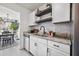 A kitchen featuring white cabinets, granite countertops, undermount sink, dark hardware and wood shelving at 207 Allen Richard Ct # B, Moncks Corner, SC 29461