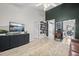 A living room features vaulted ceiling, modern entertainment center and view into dining area at 207 Allen Richard Ct # B, Moncks Corner, SC 29461