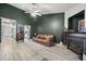 A living room featuring vaulted ceiling, a brown leather sofa, fireplace and wood-look floors at 207 Allen Richard Ct # B, Moncks Corner, SC 29461