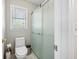 The bathroom features a modern toilet and a frosted glass shower door at 2233 Glendale Dr, Charleston, SC 29414