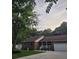 Charming brick home with well-manicured lawn, mature trees, and inviting front porch with white railings at 2233 Glendale Dr, Charleston, SC 29414