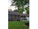 Charming brick home with well-manicured lawn, mature trees, and inviting front porch with white railings at 2233 Glendale Dr, Charleston, SC 29414