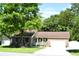 Beautiful brick home featuring a well-kept lawn, mature trees, and an attached two car garage at 2233 Glendale Dr, Charleston, SC 29414