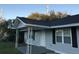 Home with front porch and gray siding, black shutters, and a new black roof at 2317 Elegans Drive Dr, North Charleston, SC 29405