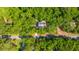 Aerial view of the property highlighting its location near a quiet street surrounded by mature trees at 2468 Marina Rd, Wadmalaw Island, SC 29487